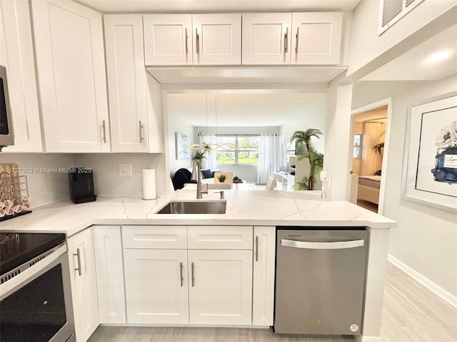 kitchen featuring sink, stainless steel appliances, and white cabinets