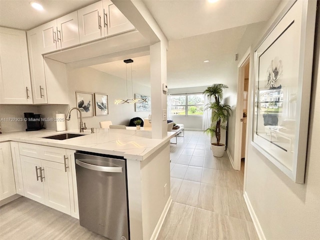 kitchen featuring sink, white cabinetry, light stone counters, dishwasher, and kitchen peninsula