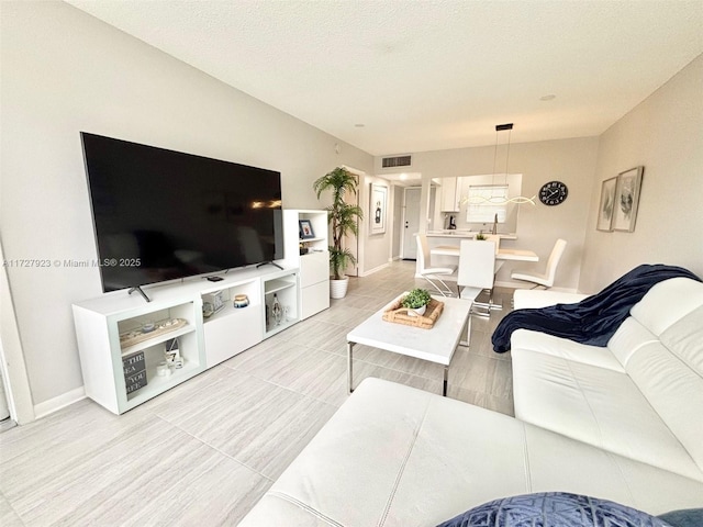 living room featuring a textured ceiling