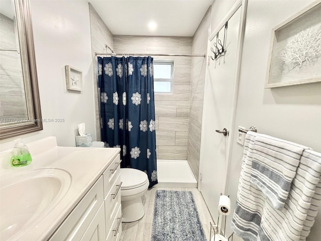 bathroom featuring a shower with curtain, vanity, and toilet