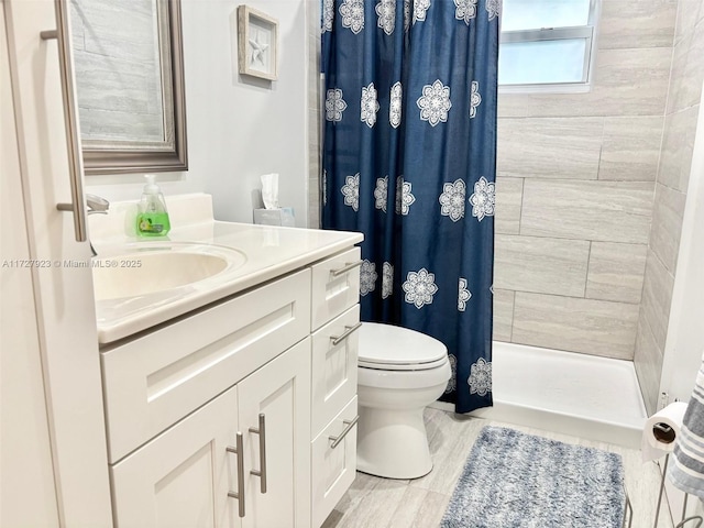 bathroom featuring a shower with curtain, vanity, toilet, and hardwood / wood-style floors