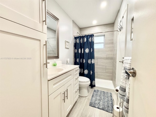 bathroom with vanity, toilet, and a shower with shower curtain