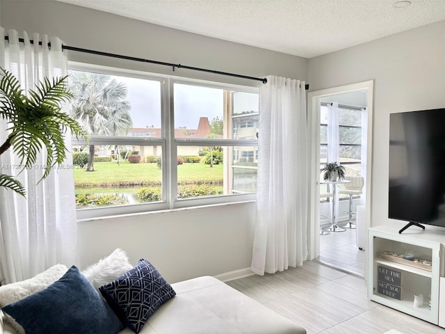 bedroom featuring multiple windows and a textured ceiling