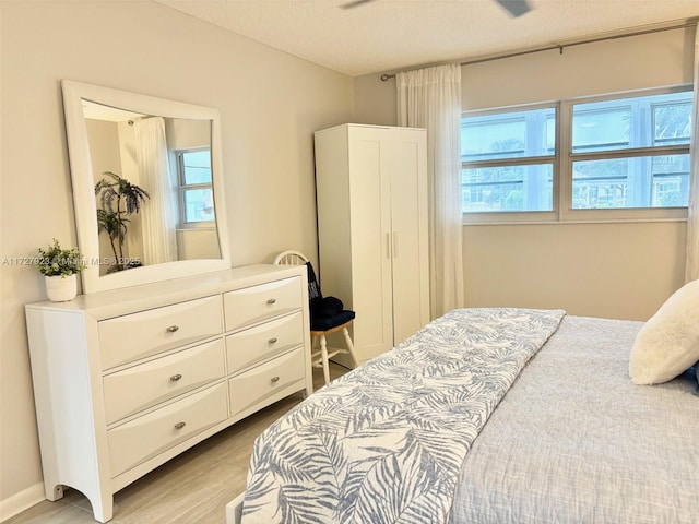 bedroom featuring a textured ceiling and light wood-type flooring