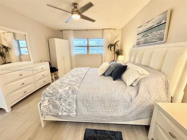 bedroom with ceiling fan and light wood-type flooring