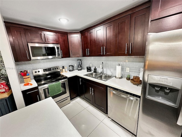 kitchen with light tile patterned floors, decorative backsplash, sink, and stainless steel appliances