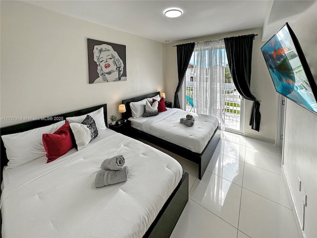 bedroom featuring tile patterned floors and access to outside