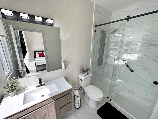 bathroom with toilet, a shower with shower door, and vanity