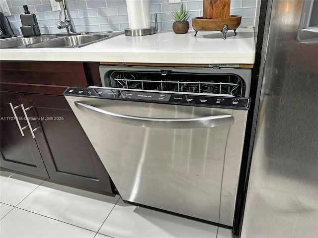 interior details featuring decorative backsplash, sink, stainless steel dishwasher, and dark brown cabinets