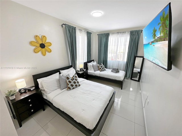 bedroom with light tile patterned floors