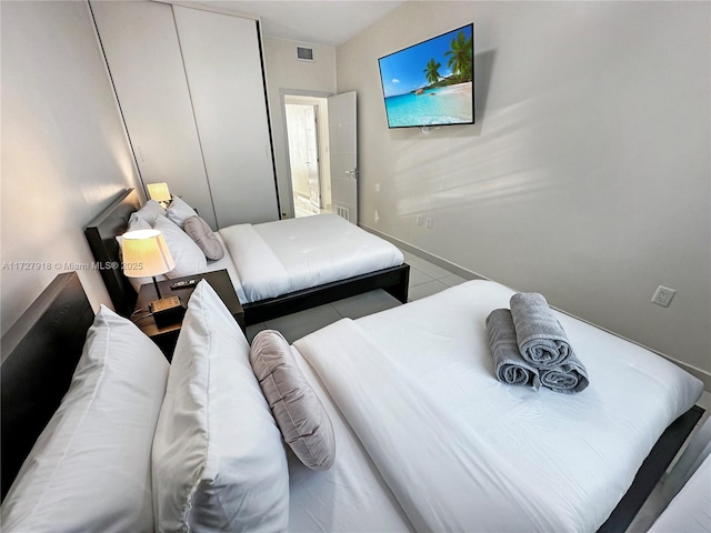 tiled bedroom featuring a closet