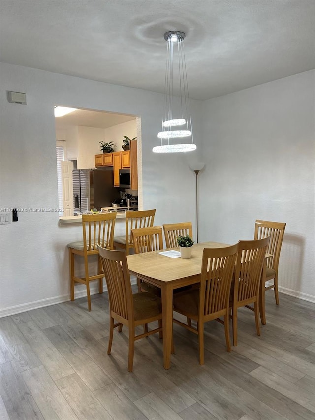 dining space with light hardwood / wood-style flooring