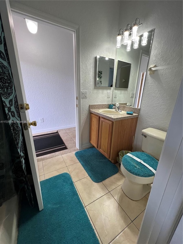 bathroom featuring tile patterned floors, vanity, and toilet