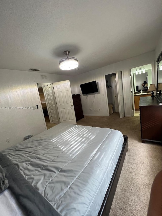 bedroom with a textured ceiling and carpet flooring