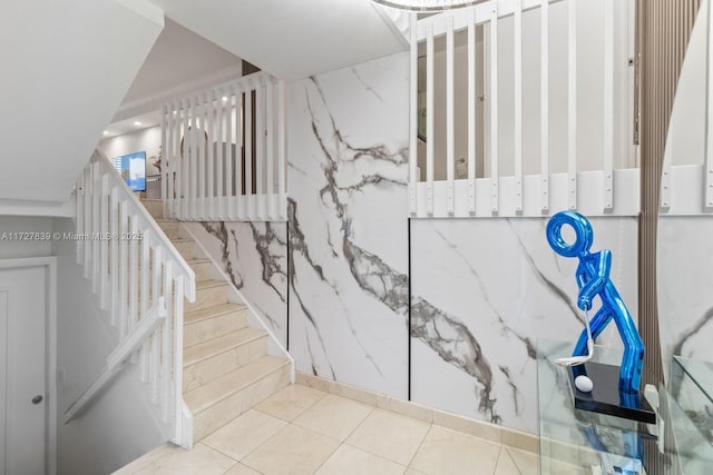 stairs featuring tile patterned flooring and tile walls