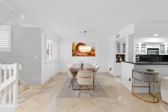 dining area with crown molding