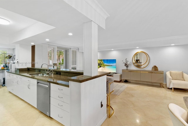 kitchen featuring white cabinets, dark stone counters, sink, and crown molding