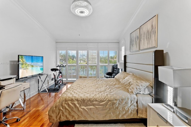 bedroom with light hardwood / wood-style flooring and ornamental molding