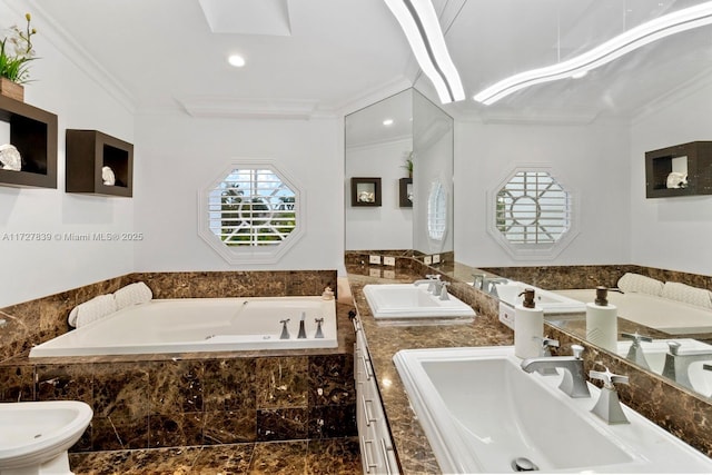 bathroom featuring tiled bath, ornamental molding, a bidet, and vanity