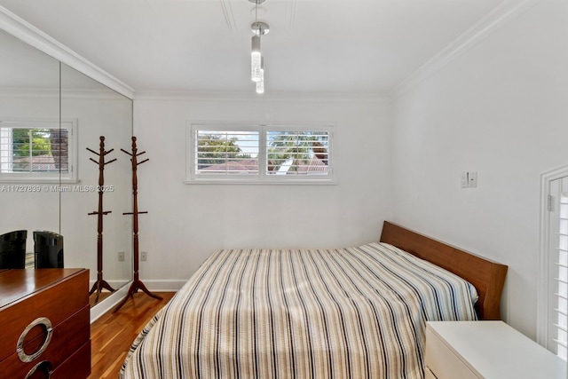 bedroom featuring wood-type flooring and crown molding