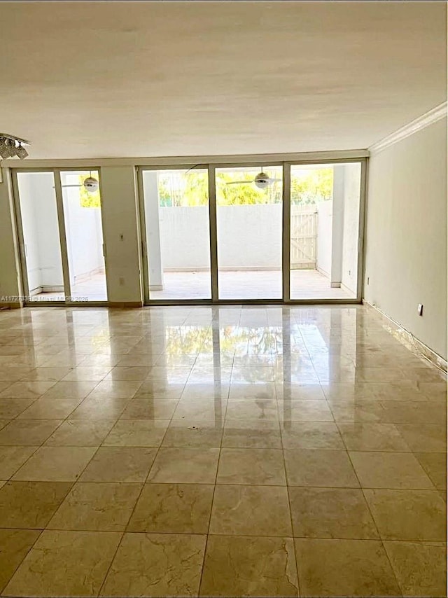 empty room with a wealth of natural light and ornamental molding