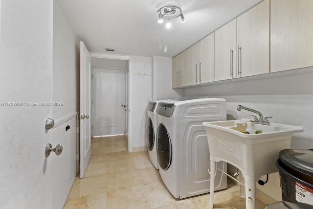 laundry area with cabinets and independent washer and dryer