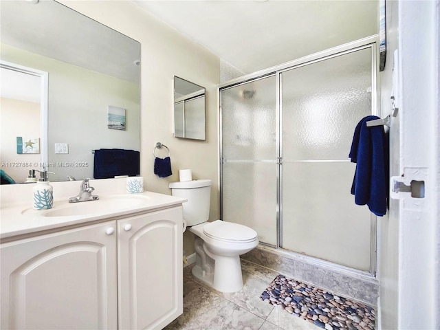 bathroom featuring walk in shower, vanity, tile patterned floors, and toilet