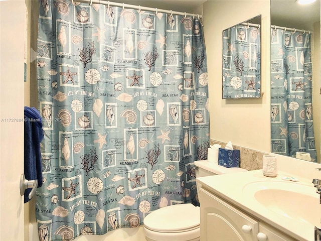 bathroom with toilet and vanity