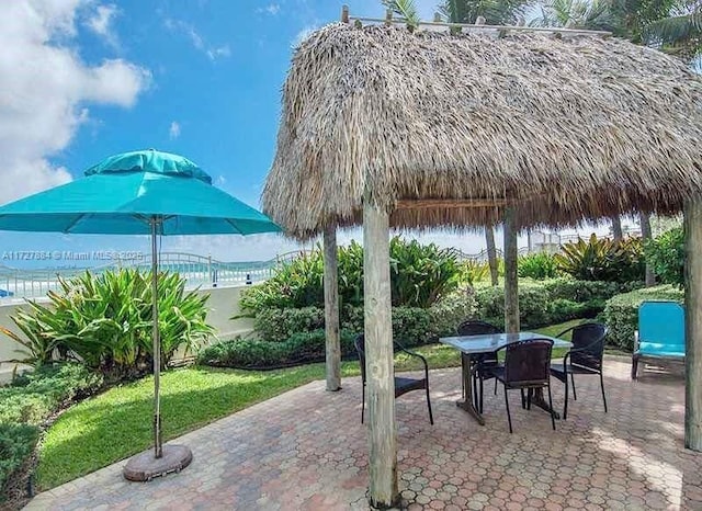 view of patio / terrace featuring a water view and a gazebo