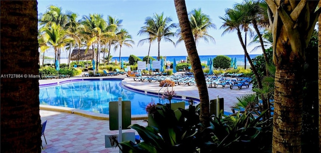 view of swimming pool with a water view