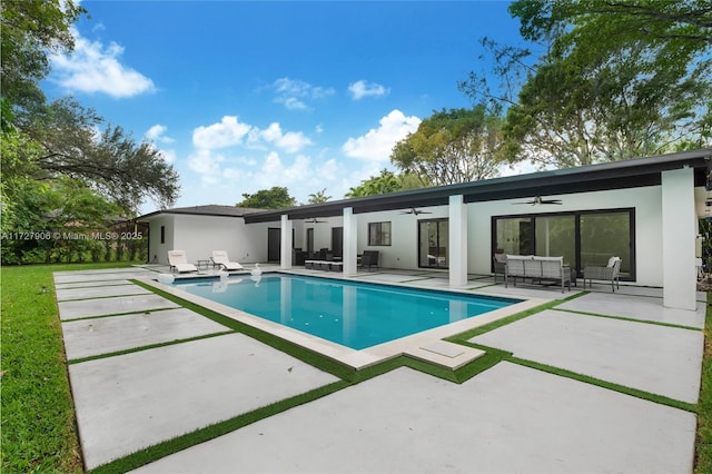 view of swimming pool featuring ceiling fan, outdoor lounge area, and a patio area