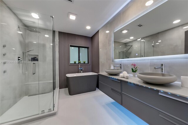 bathroom with vanity and plus walk in shower