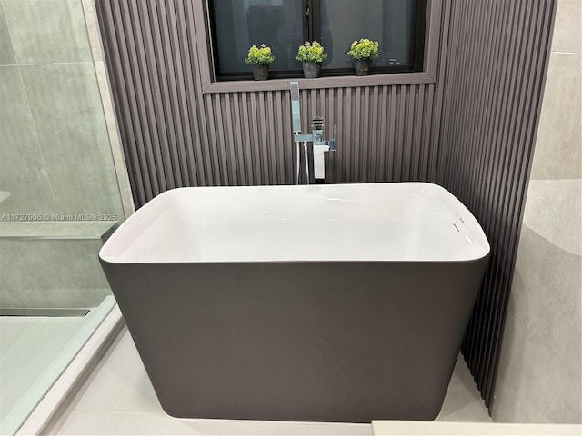 bathroom featuring tile patterned flooring and a bathing tub