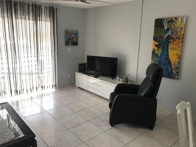 living room with ceiling fan and light tile patterned floors