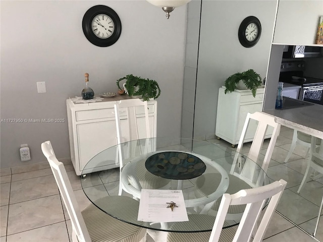 dining area featuring light tile patterned flooring