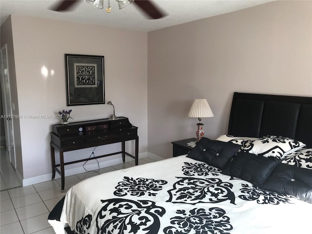 tiled bedroom featuring ceiling fan