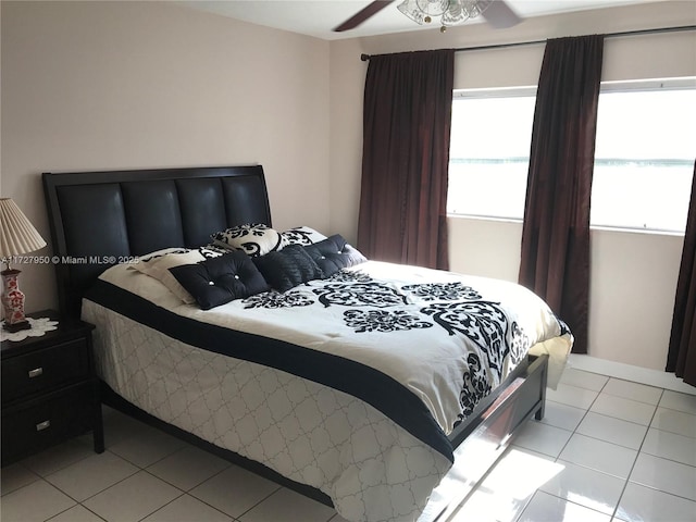 tiled bedroom featuring ceiling fan