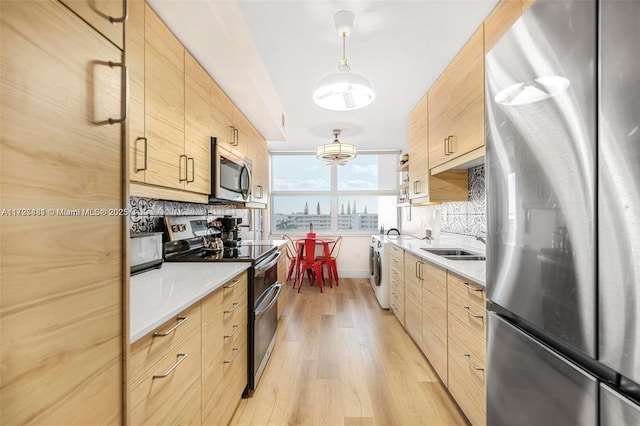 kitchen featuring tasteful backsplash, light wood-type flooring, light brown cabinets, and stainless steel appliances