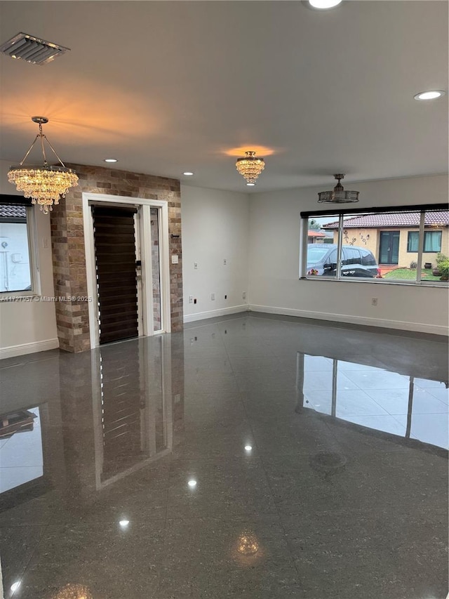 unfurnished living room with an inviting chandelier