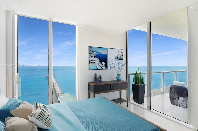 tiled bedroom with a wall of windows and a water view