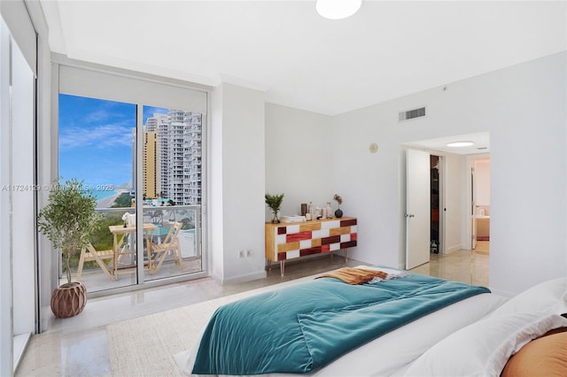 bedroom featuring access to exterior and floor to ceiling windows