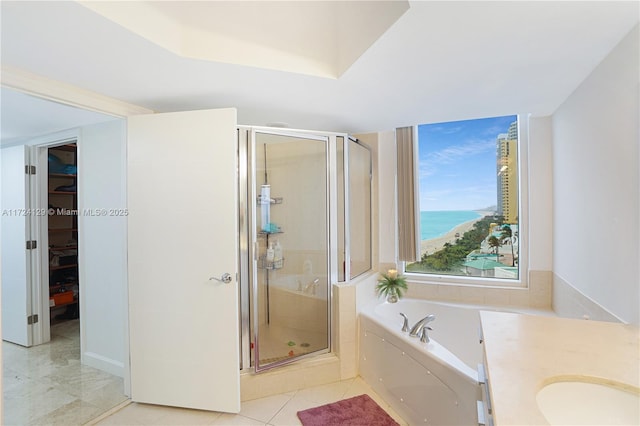 bathroom with vanity, a water view, tile patterned floors, and separate shower and tub