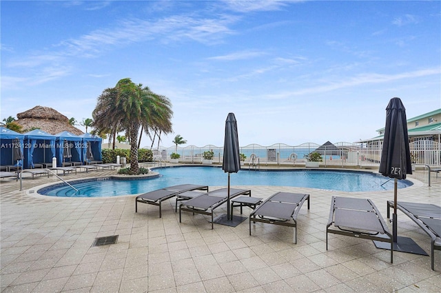 view of pool with a mountain view and a patio area