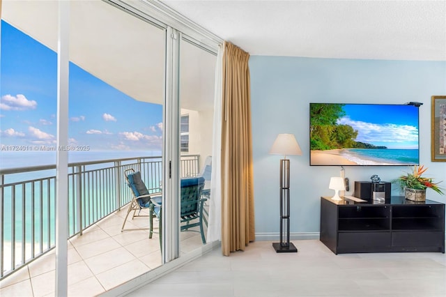 tiled living room with a water view and a healthy amount of sunlight