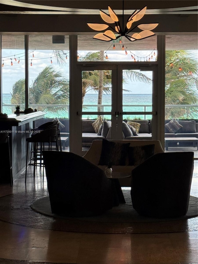 dining area featuring a water view and french doors