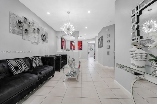 living room with an inviting chandelier and light tile patterned floors