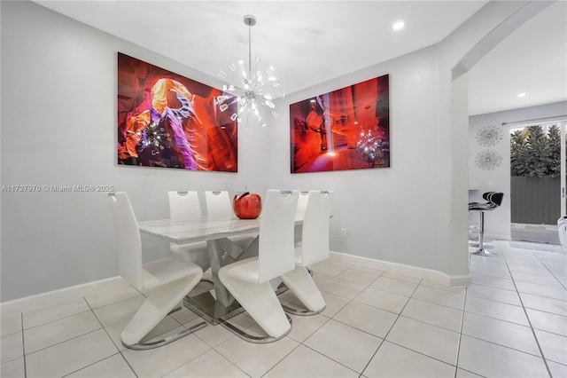 dining space featuring light tile patterned floors and a chandelier