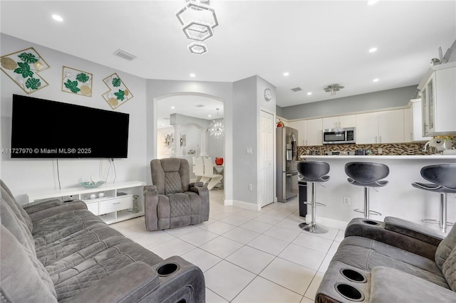 living room with light tile patterned flooring and a chandelier