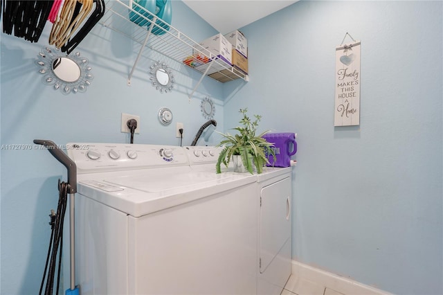 clothes washing area featuring light tile patterned flooring and independent washer and dryer