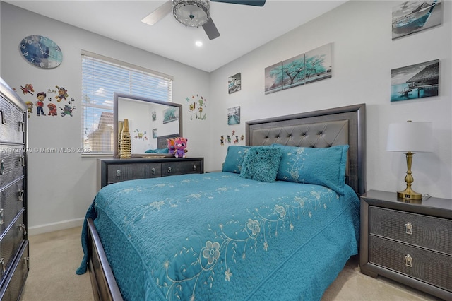 bedroom with ceiling fan and light carpet